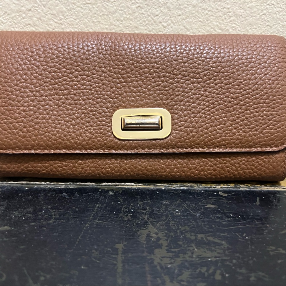 Michael Kors Chic Brown Leather Wallet with Gold Accent and many pockets.